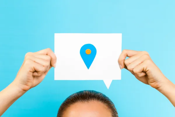 local marketing concept with blue background and large text bubble with a location pin