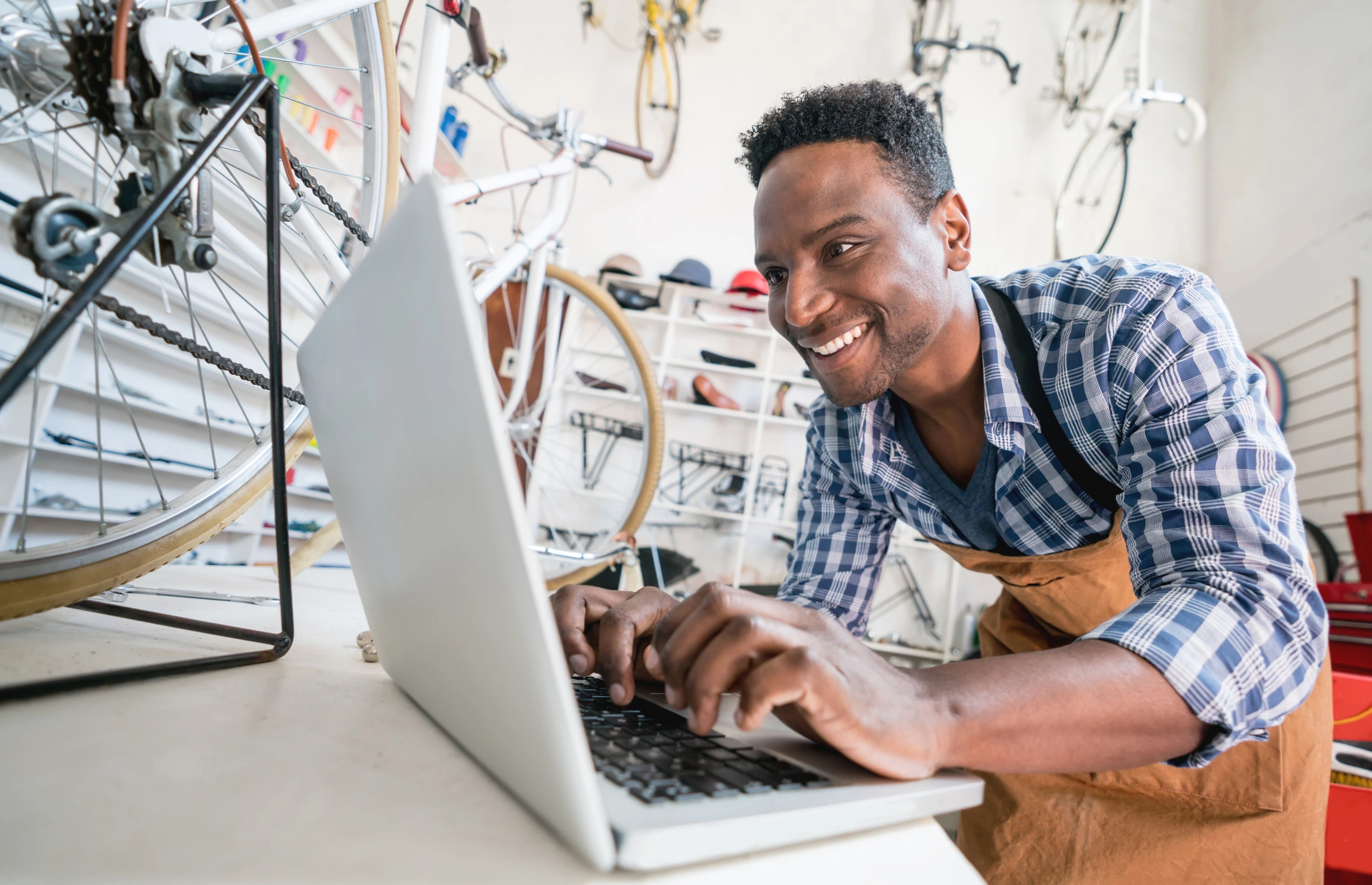Excited business owner at his bicycle shop responding to reviews on google