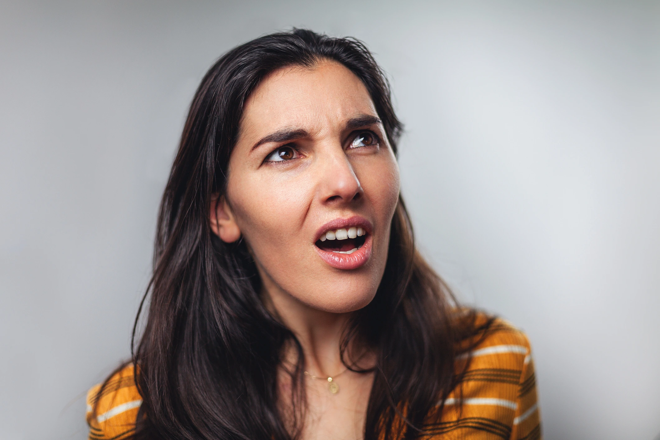 woman staring off making a grimace face