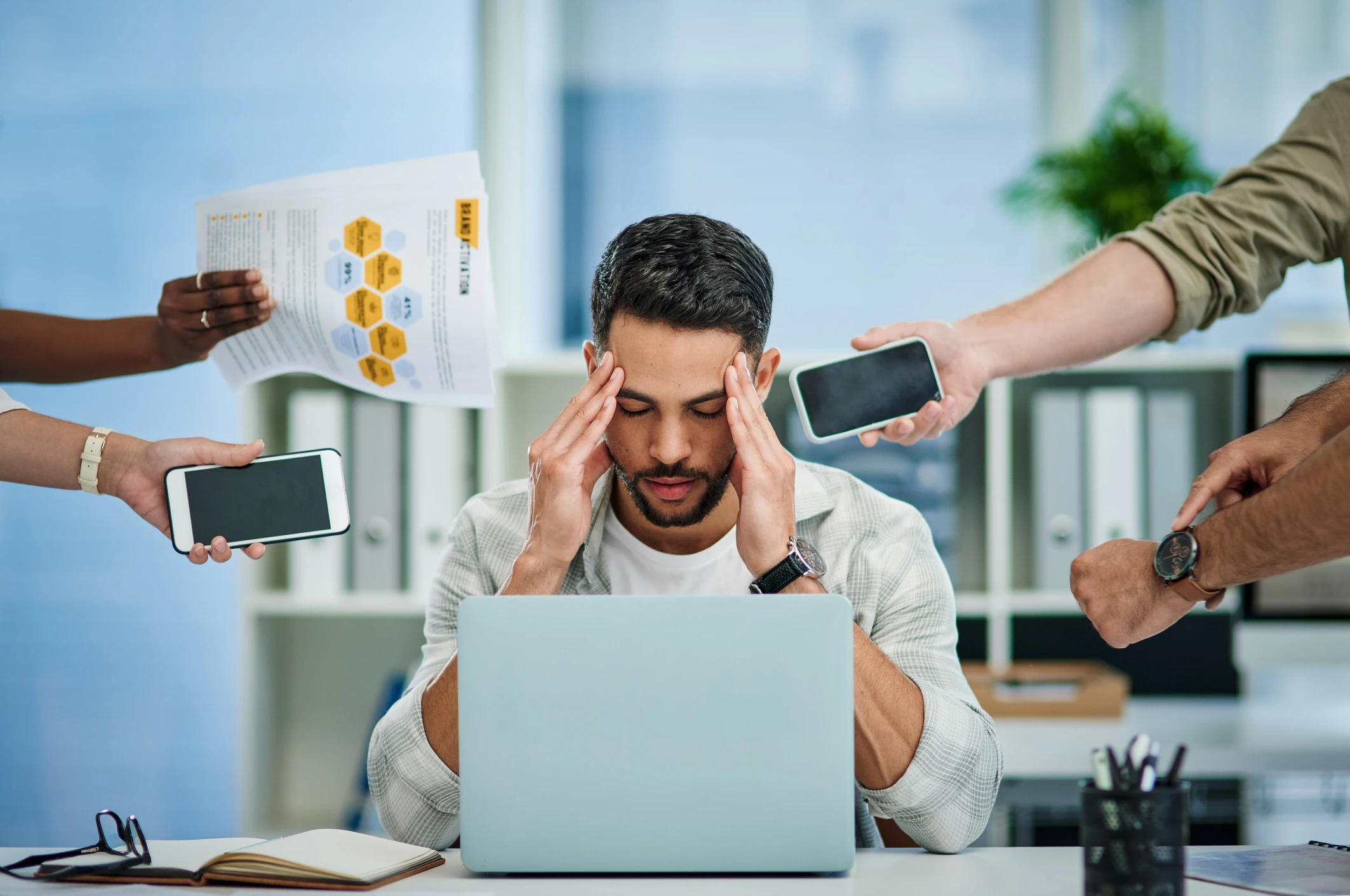 man feeling overwhelmed at work by trying to balance digital marketing and production
