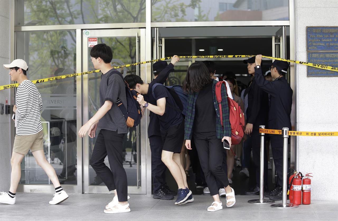 Students come out of an engineering faculty building at Yonsei University in Seoul, South Korea, Tuesday, June 13, 2017. A South Korean professor in the mechanical engineering department was injured Tuesday after opening a concealed explosive device brought to his university office in Seoul, police said. (AP Photo/Ahn Young-joon)