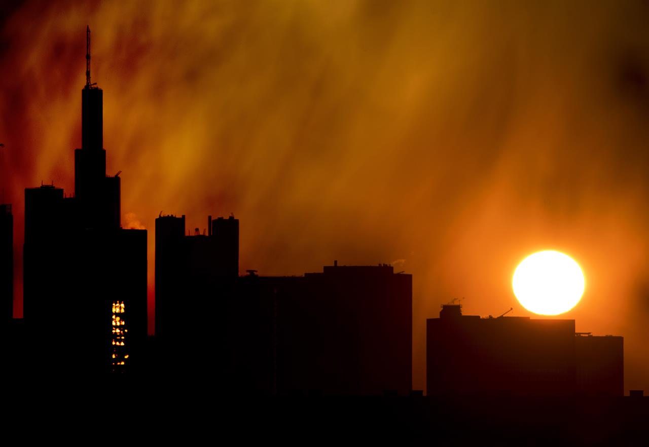The sun rises over the buildings of the banking district in Frankfurt, Germany, Thursday, April 11, 2019. (AP Photo/Michael Probst)
German authorities raid homes, offices in tax fraud probe