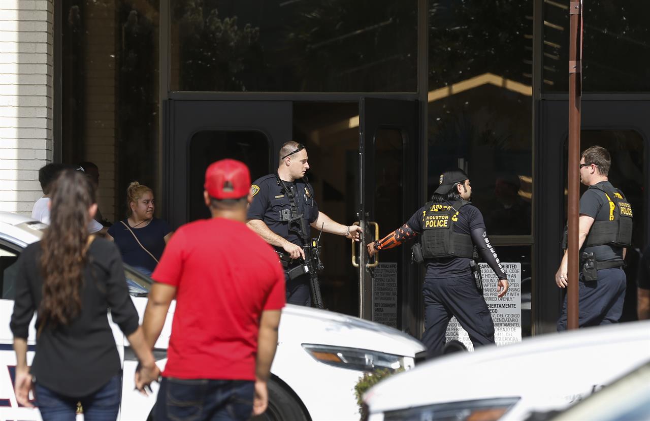 In this Sunday, Aug. 11, 2019, photo, people stand outside Memorial City Mall in Houston, as police investigate a disturbance causing an evacuation of the shopping center. Hundreds of panicked people rushed out of the Texas mall after a masked man jumped on a food court table and said he would kill himself before throwing down an unknown object covered in toilet paper. (Brett Coomer/Houston Chronicle via AP)
Masked man throwing object incites panic at Houston mall