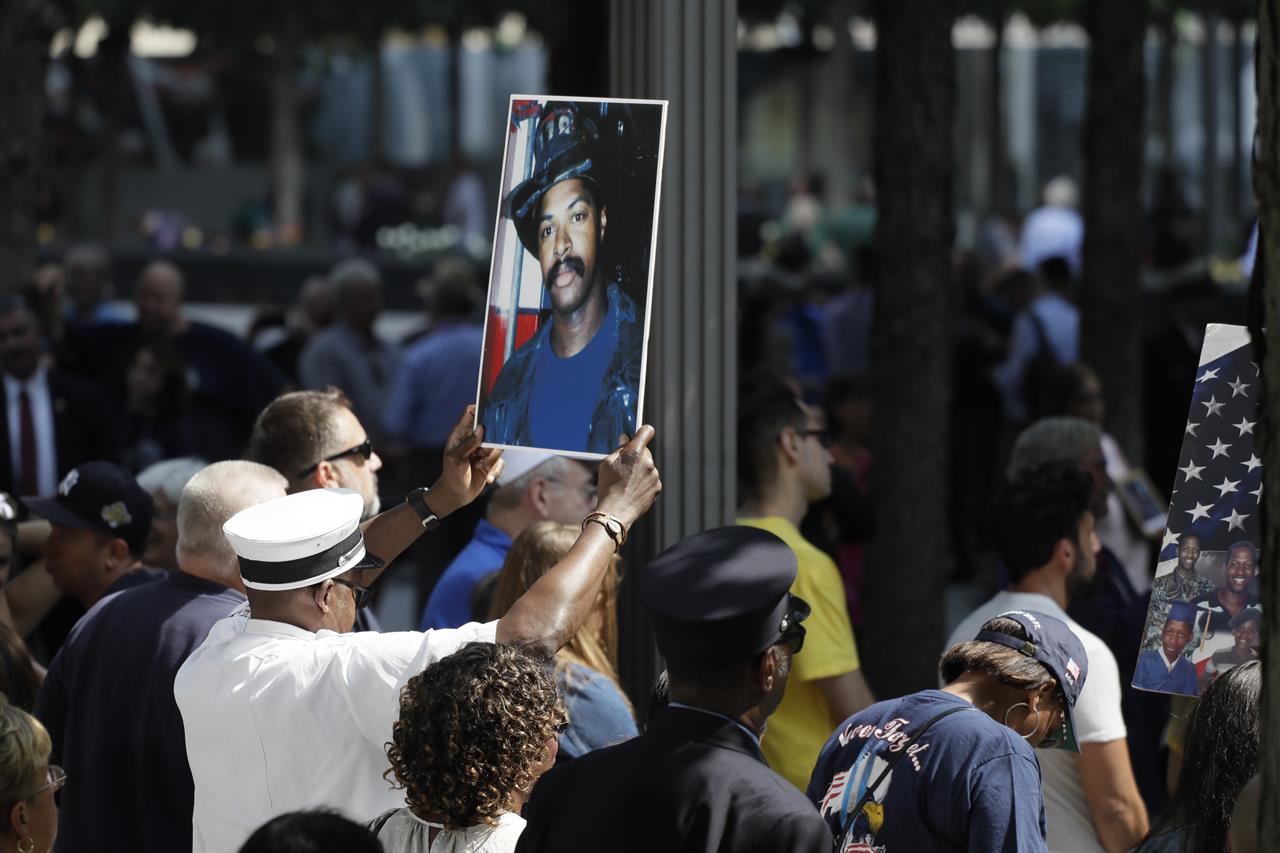 A photograph of fallen firefighter Leon Smith, Jr. is held up during a ceremony marking the 18th anniversary of the attacks of Sept. 11, 2001 at the National September 11 Memorial, Wednesday, Sept. 11, 2019 in New York. (AP Photo/Mark Lennihan)
18 years later, America vows to 'never forget' 9/11