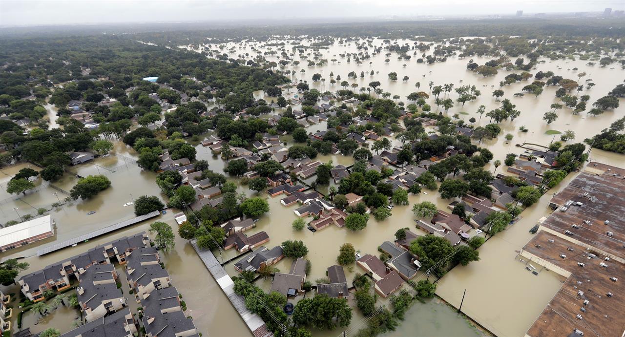 FILE - In this Aug. 29, 2017, file photo, a neighborhood near Addicks Reservoir is flooded by rain from Tropical Storm Harvey in Houston. A new study finds that FEMA buys flood-prone homes more often in wealthy, populous counties than in poor, rural areas, even though lower-income rural areas may be more likely to flood frequently. Harris County, Texas, where Houston is located, which, according to its flood control district, undergoes a major flood about every two years, has used FEMA’s buyout programs more than any other county, the researchers said. (AP Photo/David J. Phillip, File)
Wealthy counties get many FEMA buyouts of flood-prone homes