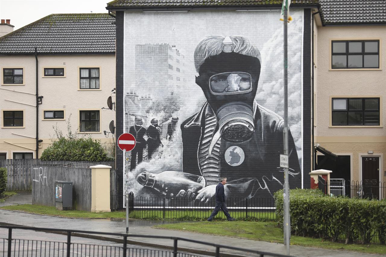 In this photo dated Monday Oct. 14, 2019 a man walks past an Irish Republican mural depicting scenes of the Battle of the Bogside area of Derry in August 1969. (AP Photo/Peter Morrison)
Brexit ignites fears of renewed violence in Northern Ireland