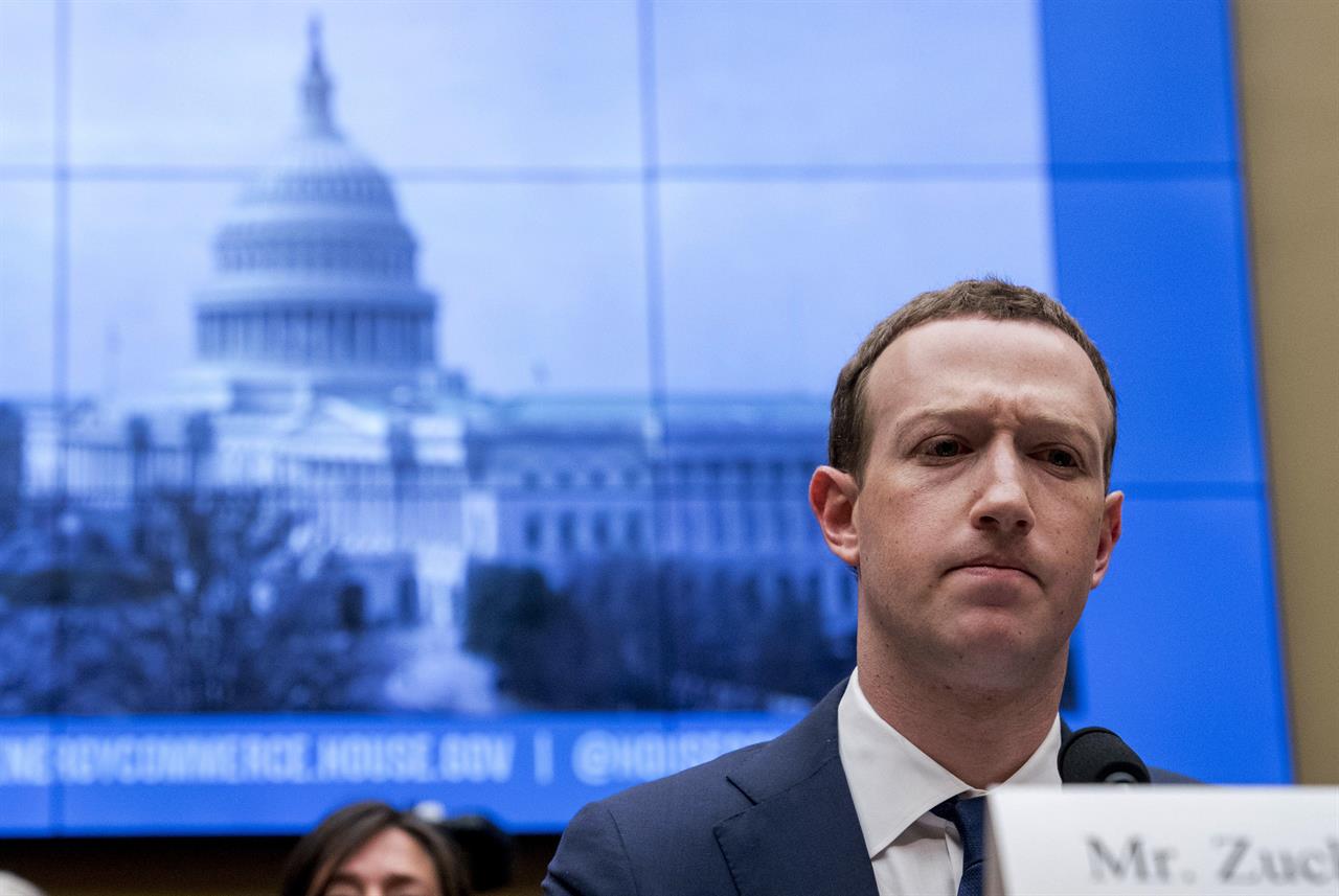 FILE - In this April 11, 2018, file photo, Facebook CEO Mark Zuckerberg pauses while testifying before a House Energy and Commerce hearing on Capitol Hill in Washington about the use of Facebook data to target American voters in the 2016 election and data privacy. Zuckerberg plans to tell Congress Wednesday, Oct. 23, 2019, that the company’s planned Libra cryptocurrency won’t launch unless all U.S. regulators approve. (AP Photo/Andrew Harnik, File)
Facebook says Libra won't launch without US approval