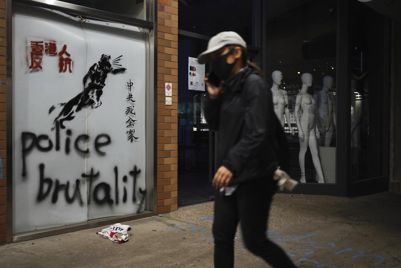 A protester walks past graffiti depicting police as a dog and various slogans including "Hongkongers Resist, "Chinese Communist whole family die" at the Hong Kong Polytechnic University in Hong Kong on Wednesday, Nov. 20, 2019. A small band of anti-government protesters, their numbers diminished by surrenders and failed escape attempts, remained holed up at a Hong Kong university early Wednesday as they braced for the endgame in a police siege of the campus. (AP Photo/Vincent Yu)
Senate passes bill to support human rights in Hong Kong