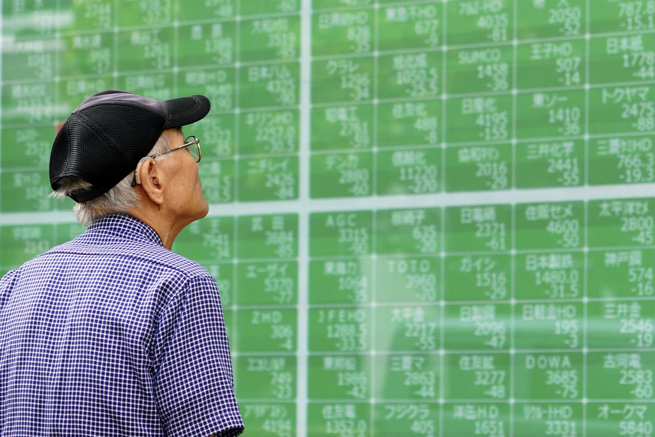In this Oct. 3, 2019, photo, a man looks at an electronic stock board showing Japan's Nikkei 225 index at a securities firm in Tokyo. Asian shares were mostly higher Tuesday, Nov. 26, 2019 on optimism over U.S.-China trade talks, prompted by Beijing’s new guidelines for the protection of patents and copyrights. (AP Photo/Eugene Hoshiko)
Global markets cautious as trade war talks grind on
