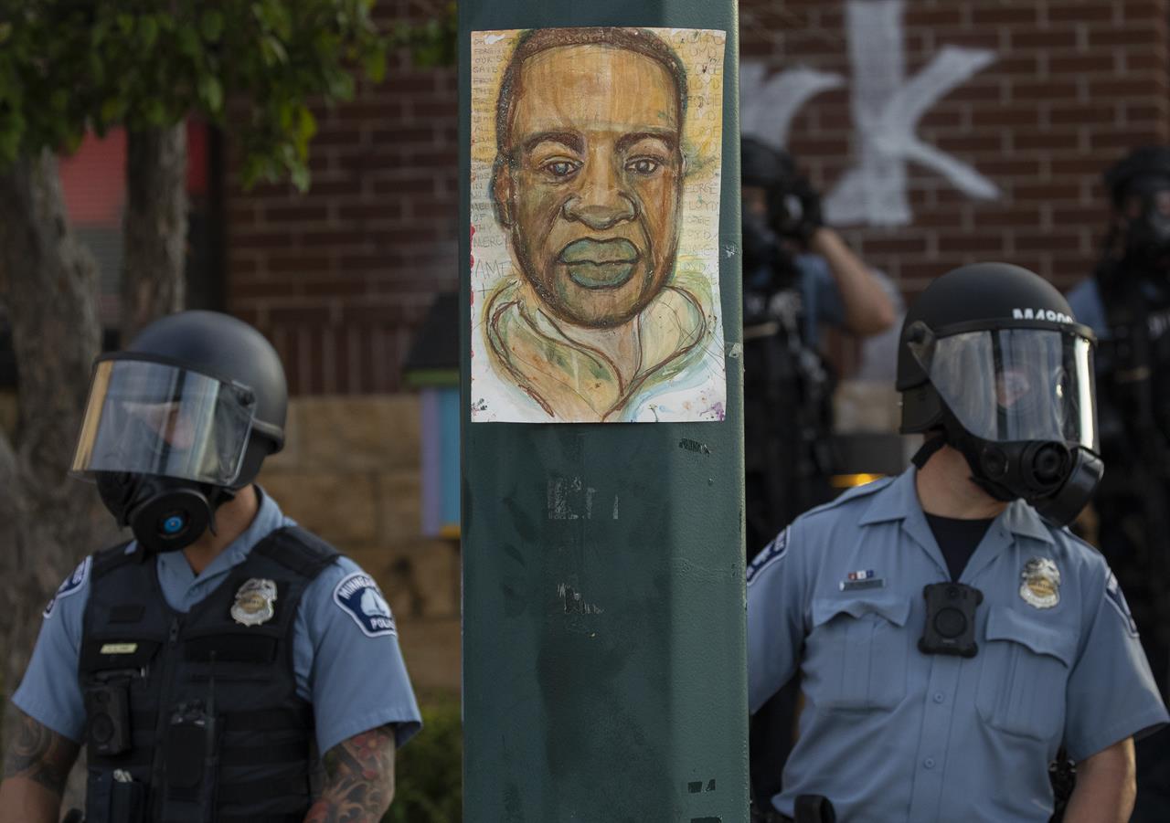 Minnesota police stand outside the department's 3rd Precinct on Wednesday, May 27, 2020, in Minneapolis. The mayor of Minneapolis called Wednesday for criminal charges against the white police officer seen on video kneeling against the neck of Floyd George, a handcuffed black man who complained that he could not breathe and died in police custody. (Carlos Gonzalez/Star Tribune via AP)
George Floyd protesters set Minneapolis police station afire