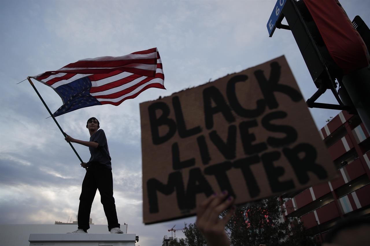 Protesters rally Saturday, May 30, 2020, in Las Vegas, over the death of George Floyd, a black man who was in police custody in Minneapolis. Floyd died after being restrained by Minneapolis police officers on Memorial Day. (AP Photo/John Locher)
AP PHOTOS: A weekend of protests in America