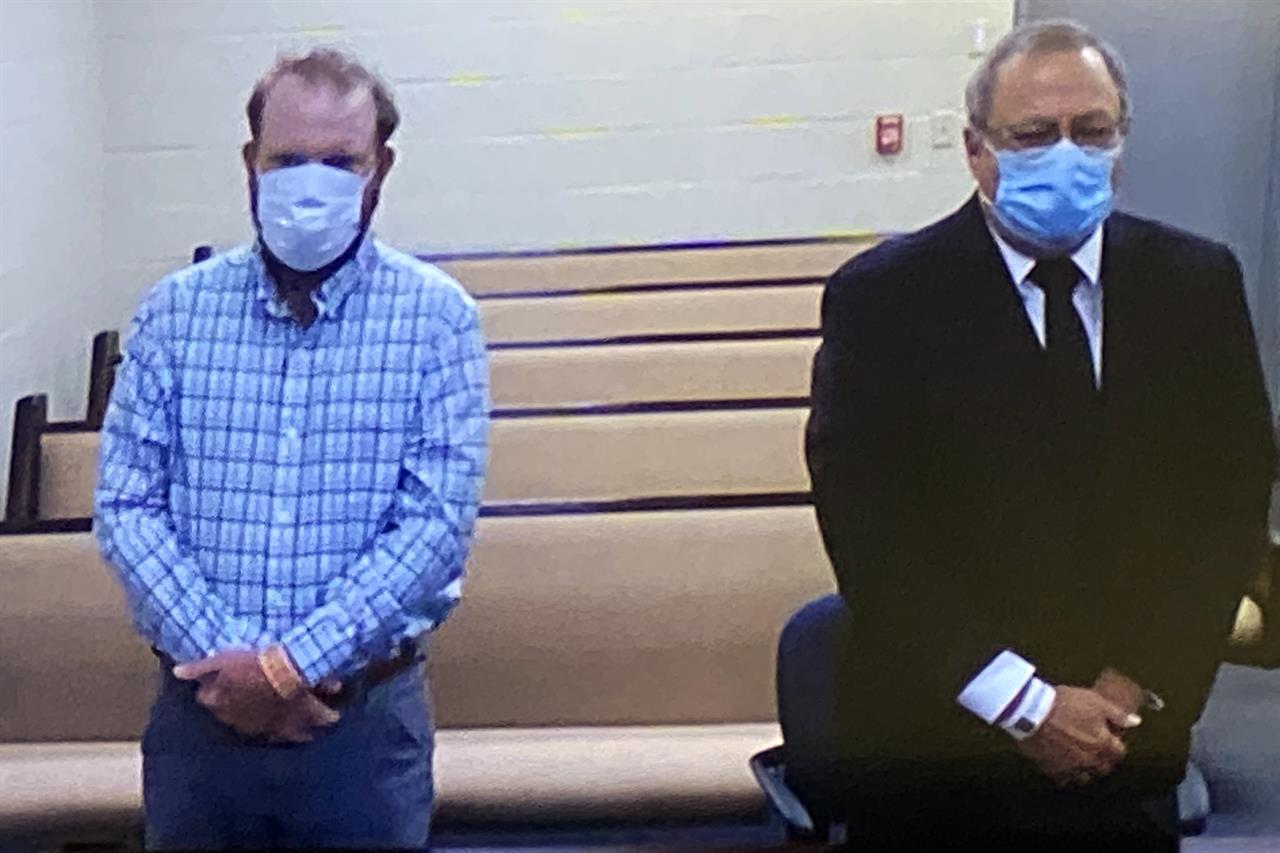 In this image made from video, Travis McMichael, left, and Greg McMichael listen to a preliminary hearing via a court video feed, Thursday, June 4, 2020, while inside the in the Glynn County jail, in Brunswick, Ga. The two men who are charged with murder in the fatal shooting of Ahmaud Arbery as well as William "Roddie" Bryan, was also arrested and charged with felony murder and illegally using a vehicle to try to confine and detain Arbery. (Glynn County Jail via AP, Pool)
Testimony: Shooter used racist slur as Arbery lay dying