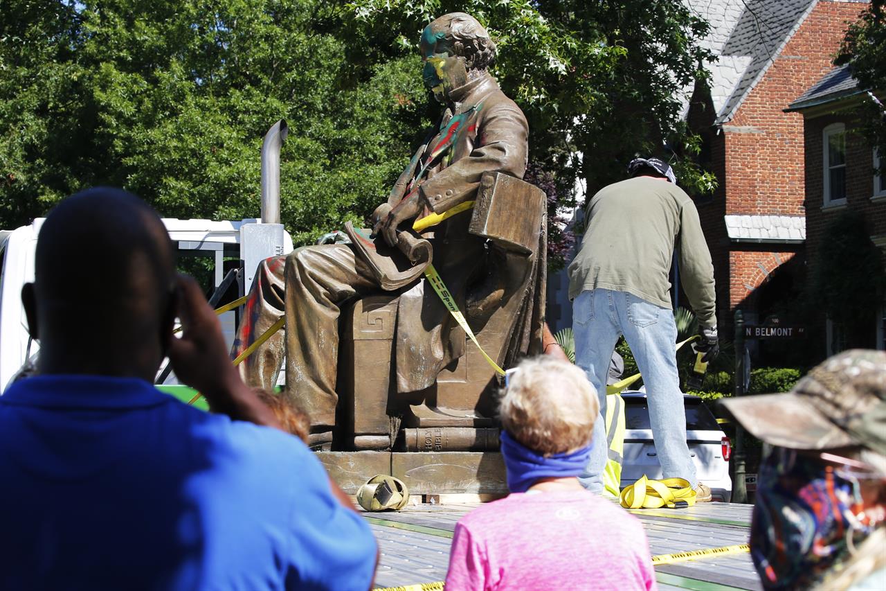 Workers secure the statue of Confederate Naval officer Matthew Fontaine Maury to a truck on Monument Avenue, Thursday, July 2, 2020, in Richmond, Va. Maury was better known for his work in oceanography and other sciences before the Civil War. His statue is the second removed since a new state law was enacted on July first. (AP Photo/Steve Helber)
Richmond removes second Confederate statue as crowd cheers