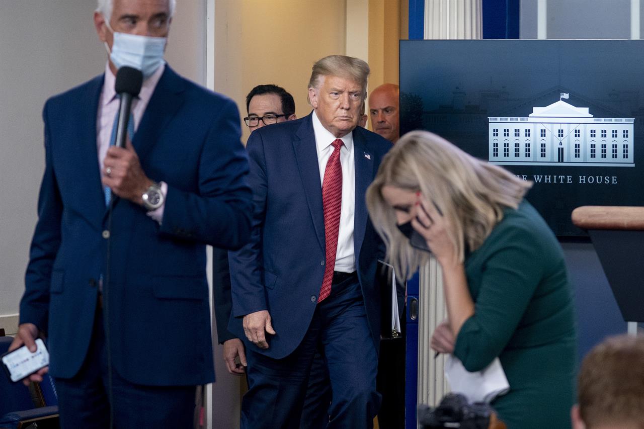 President Donald Trump returns to a news conference in the James Brady Press Briefing Room after he briefly left because of a security incident outside the fence of the White House, Monday, Aug. 10, 2020, in Washington. (AP Photo/Andrew Harnik)
Trump abruptly escorted from briefing after shooting near WH