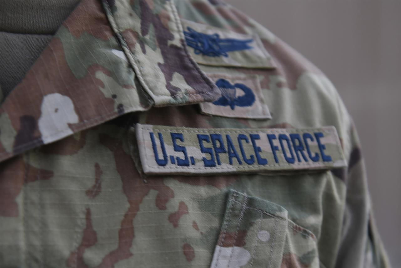 In this photo released by the U.S. Air Force, Capt. Ryan Vickers stands for a photo to display his new service tapes after taking his oath of office to transfer from the U.S. Air Force to the U.S. Space Force at Al-Udeid Air Base, Qatar, Tuesday, Sept. 1, 2020. Space Force, the first new U.S. military service since the creation of the Air Force in 1947, now has some 20 members stationed at Qatar's Al-Udeid Air Base in its first foreign deployment. (Staff Sgt. Kayla White/U.S. Air Force via AP)
US Space Force deploys to vast new frontier: Arabian Desert