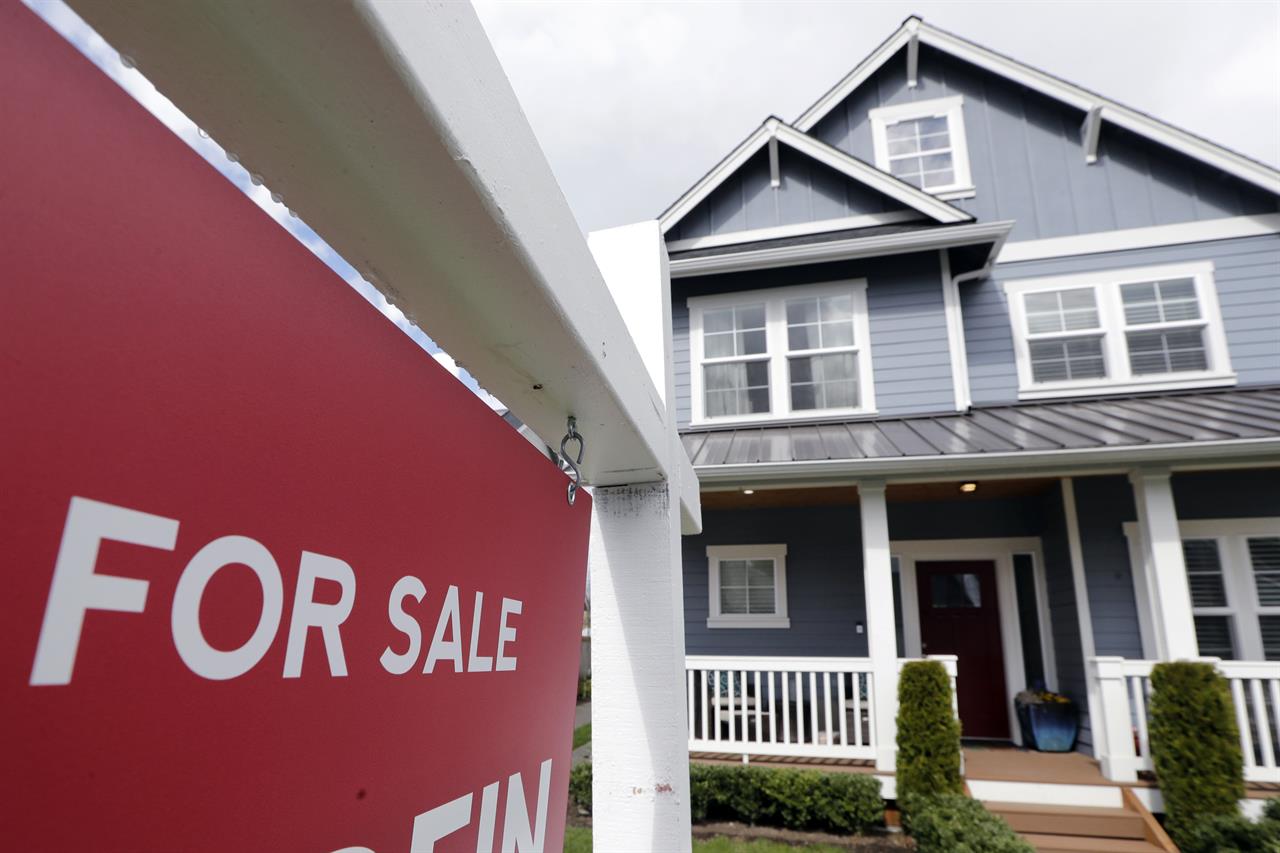 FILE - In this April 1, 2020 photo, a "For Sale" sign stands in front of a home that is in the process of being sold in Monroe, Wash., outside of Seattle. Sales of new homes rose by a very strong 4.8% in August to a seasonally-adjusted annual rate of 1.01 million units. The gains reported Thursday, Sept. 24 by the The Commerce Department follow steep declines in March and April when COVID-19 infections spread in the U.S. (AP Photo/Elaine Thompson, File)