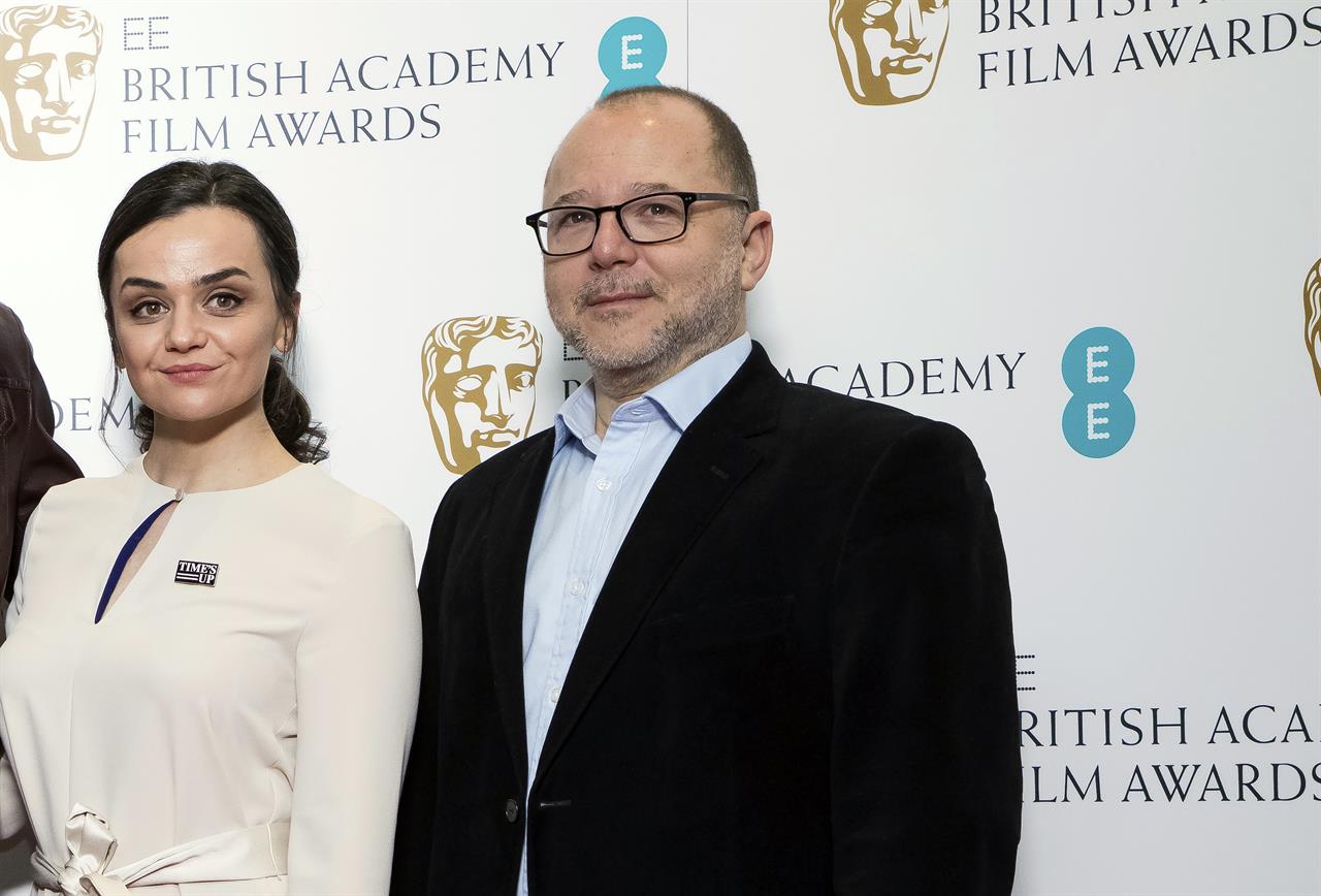 FILE - In this Wednesday, Jan. 9, 2019 file photo, BAFTA Chair of the Film Committee Marc Samuelson poses for photographers next to actor Hayley Squires in London. The British Academy of Film and Television Arts promised to change after nominations for the 2020 awards were announced last January. No women were nominated as best director for the seventh year running, and all 20 nominees in the lead and supporting performer categories were white. “We said on the day, ‘We’re going to review everything,’” BAFTA film committee chairman Marc Samuelson said Thursday, Sept. 24. 2020 as the academy announced a slate of changes. (Photo by Vianney Le Caer/Invision/AP, file)
