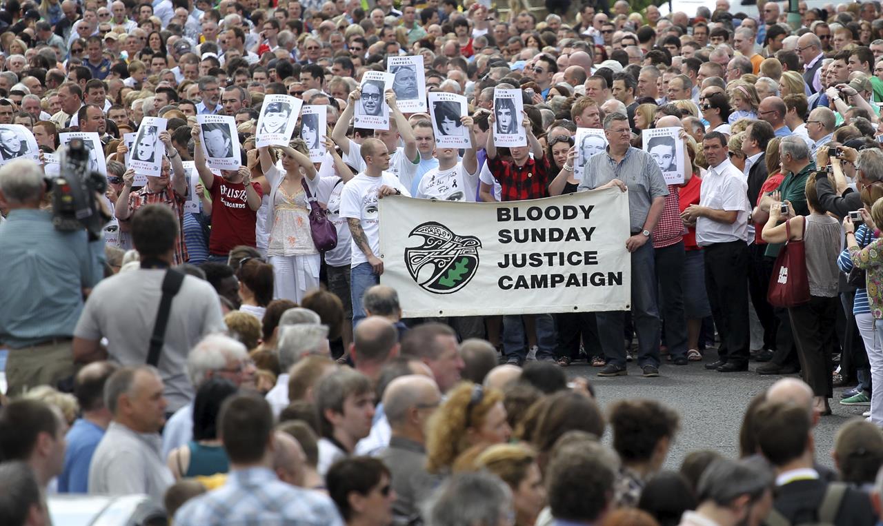FILE - In this Tuesday, June, 15, 2010 file photo, relatives and families march to the Guildhall for a preview of the Saville report into the 1972 Bloody Sunday shootings, in Londonderry, Northern Ireland. Prosecutors announced on Tuesday Sept. 29, 2020, that no more British Army veterans will be charged over the 1972 “Bloody Sunday” killings of 13 civil rights protesters in Londonderry. (AP Photo/Peter Morrison, File)