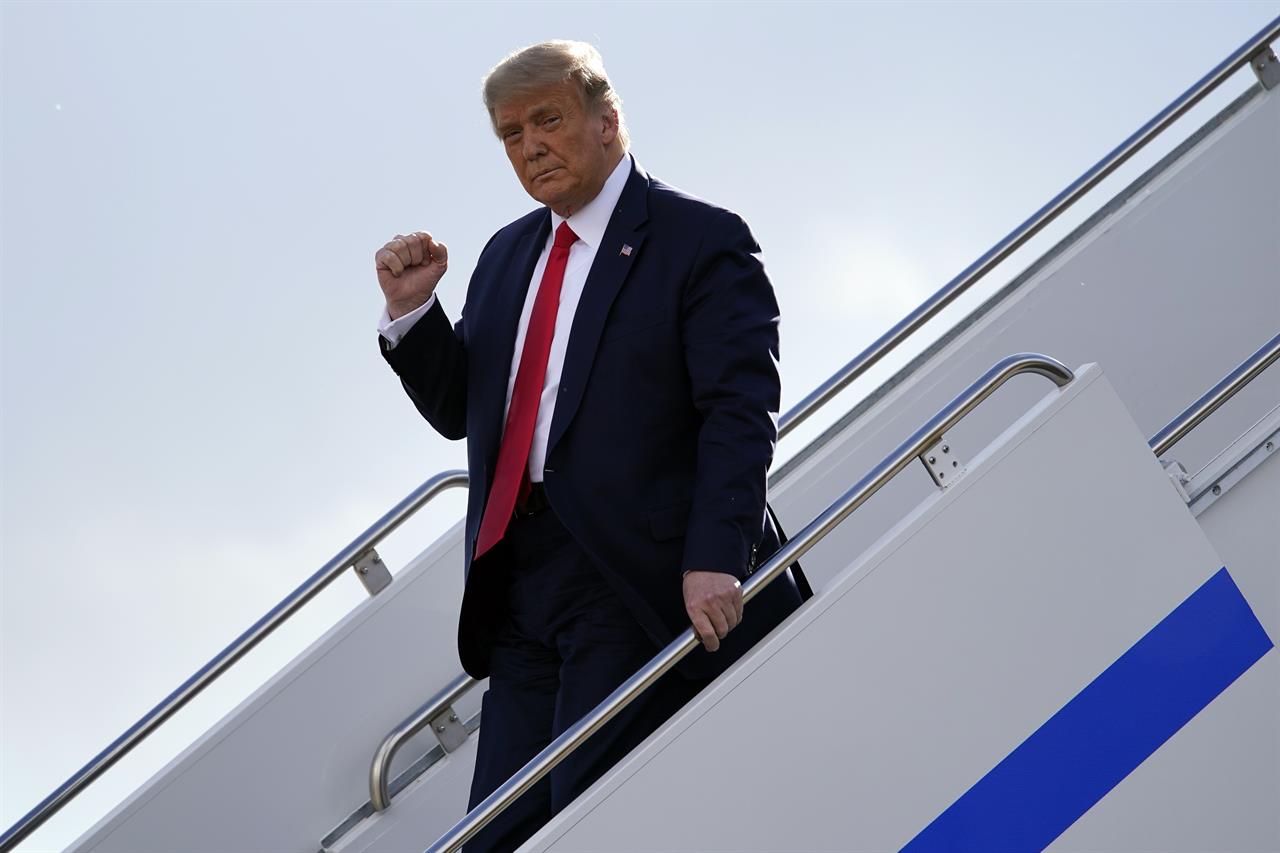 President Donald Trump gestures as he steps off Air Force One upon arrival at Minneapolis Saint Paul International Airport, Wednesday, Sept. 30, 2020, in Minneapolis. (AP Photo/Alex Brandon)