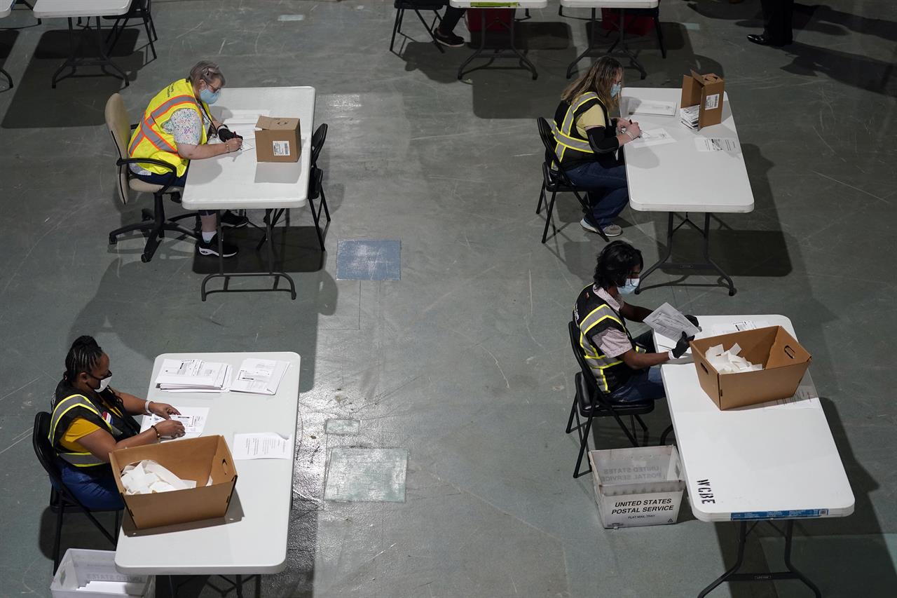 FILE - In this Thursday, Sept. 3, 2020 file photo, workers prepare absentee ballots for mailing at the Wake County Board of Elections in Raleigh, N.C. Time was dwindling for thousands of North Carolina voters to fix absentee voting errors as elections officials hustled out an updated process for handling mail-in ballot problems two weeks before Election Day. (AP Photo/Gerry Broome, File)