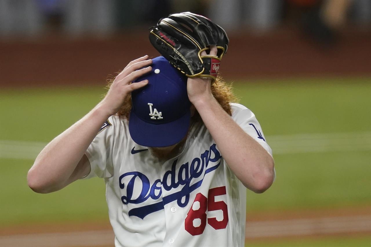 Los Angeles Dodgers starting pitcher Dustin May reacts after giving up a two-run home run to Tampa Bay Rays' Brandon Lowe during the fifth inning in Game 2 of the baseball World Series Wednesday, Oct. 21, 2020, in Arlington, Texas. (AP Photo/Eric Gay)