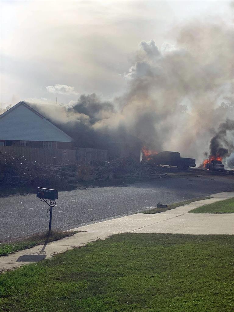 This photo provided by Greg Crippen shows the scene where a U.S. Navy training plane crashed in an Alabama residential neighborhood near the Gulf Coast, Friday, Oct. 23, 2020 near Foley, Ala. (Greg Crippen via AP)
