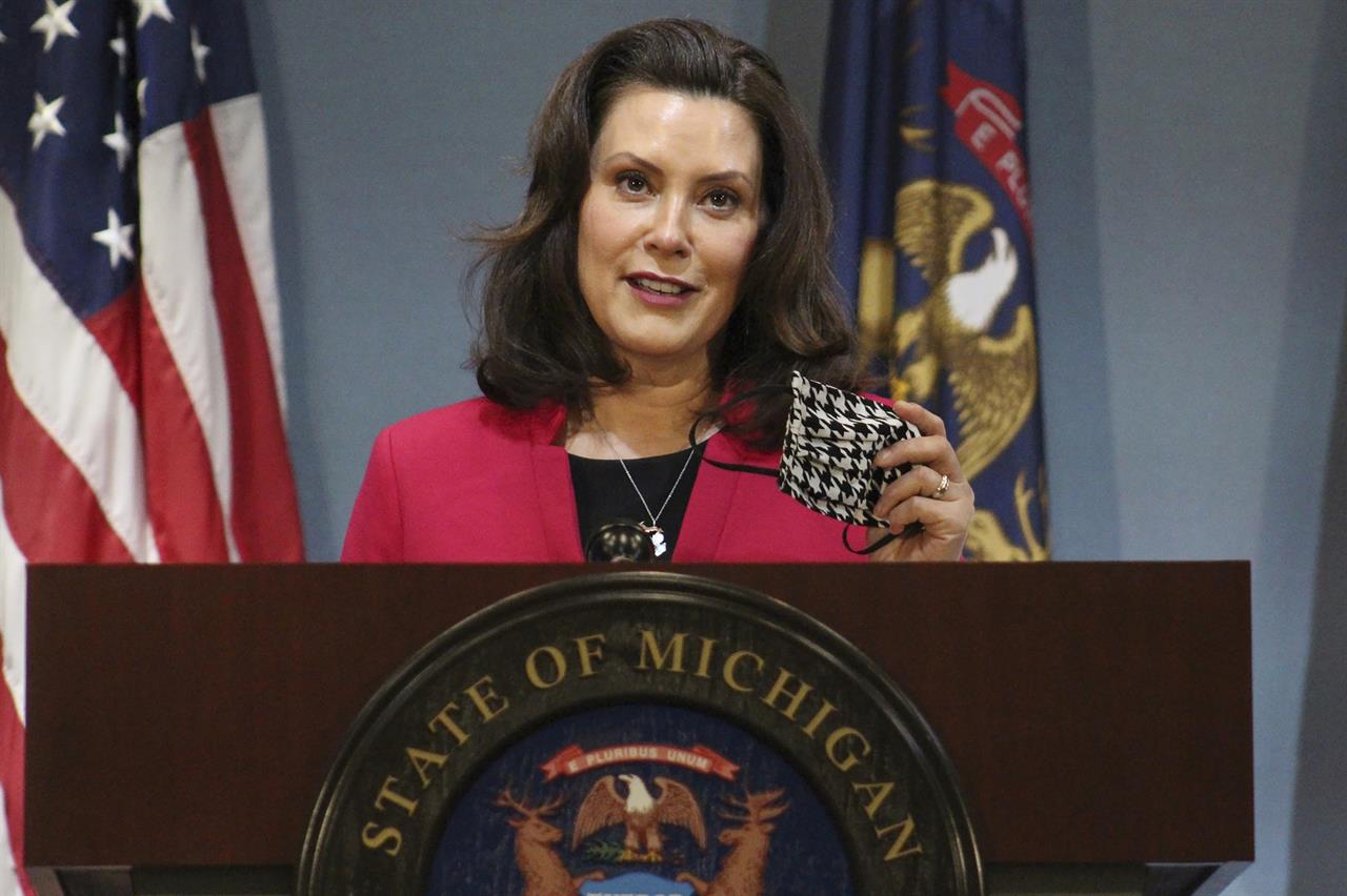 FILE - In this Thursday, May 21, 2020 file photo provided by the Michigan Office of the Governor, Michigan Gov. Gretchen Whitmer speaks during a news conference in Lansing, Mich. Gov. The Michigan Public Service Commission has some authority over Enbridge's plans to build an oil pipeline tunnel beneath the channel that connects two of the Great Lakes, a state administrative law judge ruled Friday, Oct. 23, 2020. Democratic Gov. Gretchen Whitmer has joined environmentalists and native tribes in calling for shutdown of the 67-year-old line, saying the underwater segment is vulnerable to a catastrophic rupture. (Michigan Office of the Governor via AP, Pool, File)