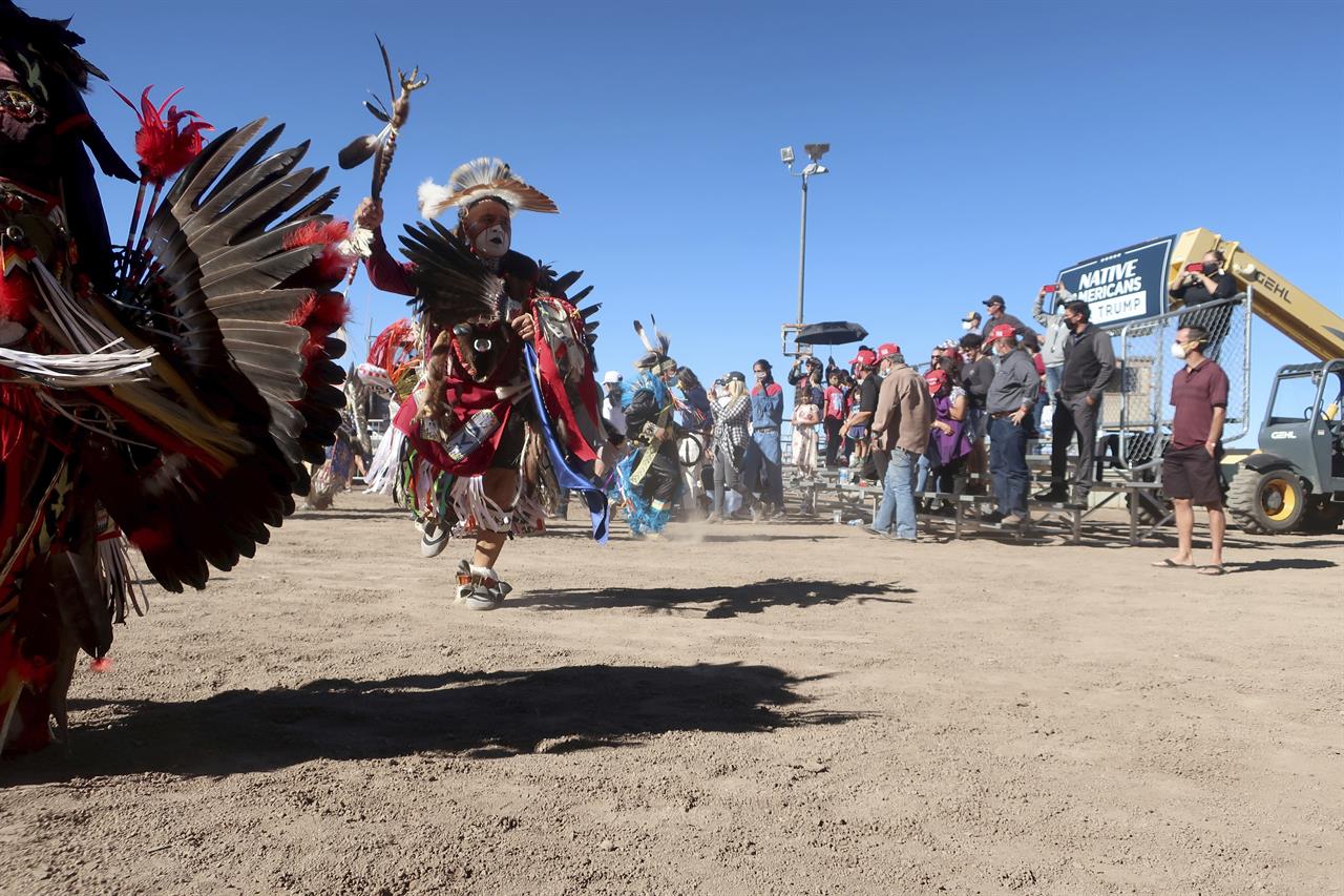 Native American dancers perform at a Donald Trump rally Oct. 15, 2020 at the rodeo grounds in Williams, Arizona. Navajo Nation President Myron Lizer makes no qualms about it: As one of the top officials on the country's largest Native American reservation, he's a proud Donald Trump supporter. Lizer says Native American values - hard work, family and ranching - align more with the GOP than with Democrats. (AP Photo/Felicia Fonseca)