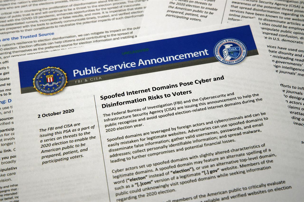 FILE - In this Oct. 6, 2020, file photo, a public service announcement from the FBI and the Department of Homeland Security cybersecurity agency. As President Donald Trump sows doubts about the election, an obscure government agency he created is working behind the scenes to inspire confidence in the vote amid unprecedented challenges. The Cybersecurity and Infrastructure Agency, which Trump signed into existence in 2018, is working with other parts of the government to safeguard an election in the middle of a pandemic. (AP Photo/Jon Elswick, File)