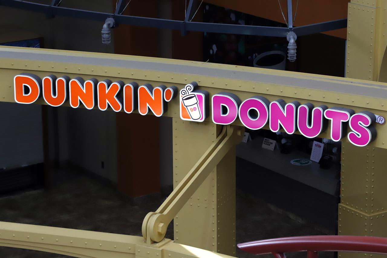 This May 7, 2020, file photo, shows a Dunkin' Donuts at the Greater Pittsburgh International Airport in Moon, Pa. The Dunkin’ doughnuts and coffee chain confirmed it's held talks to be taken private by a private equity firm, sending shares rocketing to an all-time high at the opening bell Monday, Oct. 26, 2020.(AP Photo/Gene J. Puskar, File)