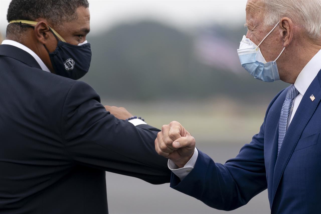 Democratic presidential candidate former Vice President Joe Biden greets Rep. Cedric Richmond, D-La., left, as he arrives at Columbus Airport in Columbus, Ga., Tuesday, Oct. 27, 2020, to travel to Warm Springs, Ga. for a rally. (AP Photo/Andrew Harnik)