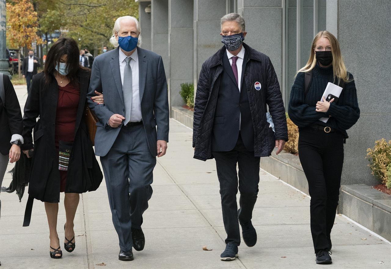 Toni Natalie, left, and India Oxenberg, right, arrive with their attorneys at Brooklyn federal court for a sentencing hearing for self-improvement guru Keith Raniere, Tuesday, Oct. 27, 2020 in New York. Raniere, whose organization NXIVM attracted millionaires and actresses among its adherents, is expected to be sentenced Tuesday on convictions that he turned some female followers into sex slaves branded with his initials. (AP Photo/Mark Lennihan)