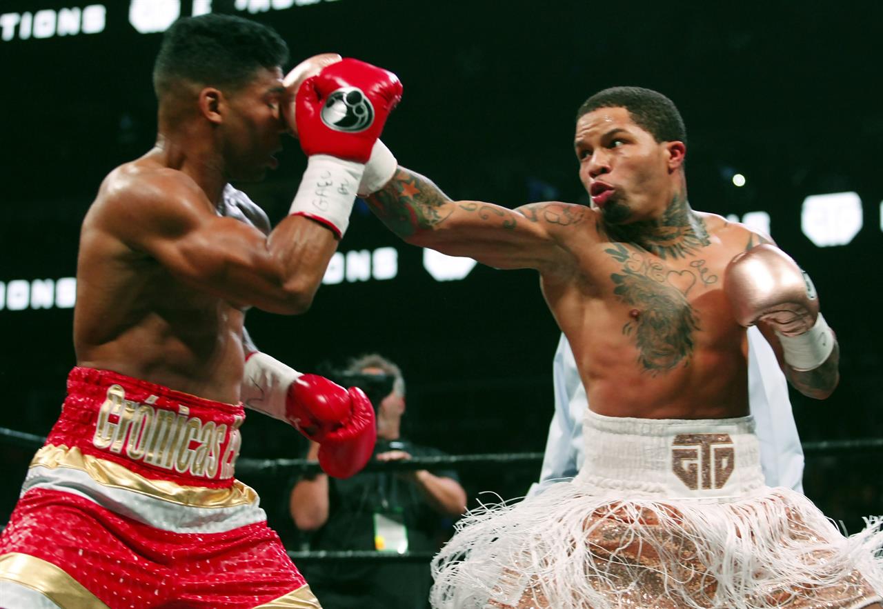 FILE - In this Dec. 29, 2019, file photo, Gervonta Davis, right, lands a punch on Yuriorkis Gamboa during round eight in their WBA lightweight bout in Atlanta. Davis wants to become a pay-per-view star, much like his promoter and mentor Floyd Mayweather Jr. was in his prime. He also wants to fight in front of a lot of screaming fans, though he’ll have to settle for a pandemic-limited audience of ticket holders Saturday in San Antonio for his title matchup with veteran Leo Santa Cruz. (AP Photo/Tami Chappell, File)