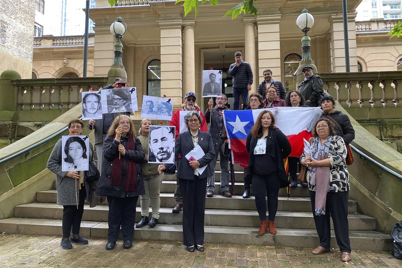 Supporters of those who disappeared in Chile in the 1970's are seen outside the Sydney Central Local Court in Sydney, Thursday, Oct. 29, 2020.An Australian judge has ruled that a woman wanted in Chile on kidnapping charges dating to Augusto Pinochet’s military dictatorship in the 1970s can be extradited. (Margaret Scheikowski, AAP Image via AP)