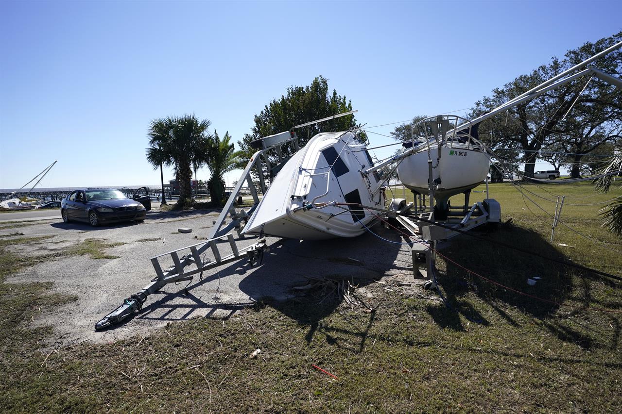 A sailboat on a trailer sits overturned in Pass Christian, Miss., Thursday, Oct. 29, 2020, in the aftermath of Hurricane Zeta, which passed through Wednesday . (AP Photo/Gerald Herbert)
