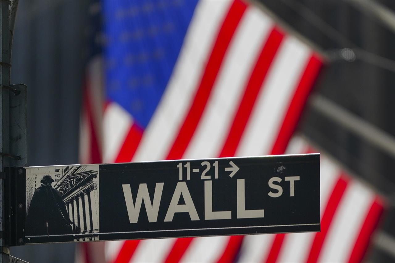 FILE - In this Oct. 14, 2020 file photo, the American Flag hangs outside the New York Stock Exchange in New York. U.S. stocks are drifting close to their record highs Wednesday, Nov. 18 as hopes for a coronavirus vaccine coming in the future collide with worries about the worsening pandemic in the present. The S&P 500 was 0.1% lower in early trading after flipping between small gains and losses. (AP Photo/Frank Franklin II, File)