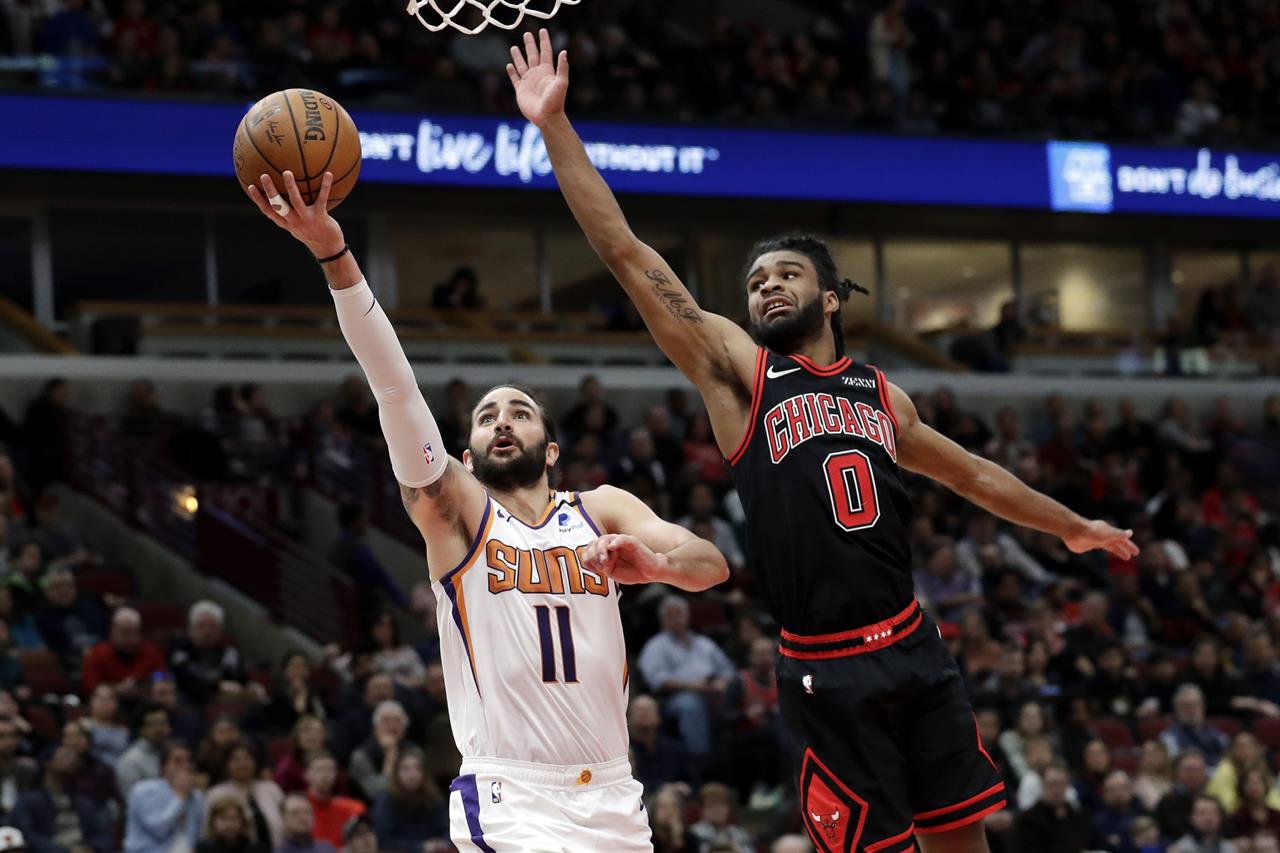 FILE - Phoenix Suns guard Ricky Rubio, left, drives to the basket past Chicago Bulls guard Coby White during the second half of an NBA basketball game in Chicago, in this Feb. 22, 2020, file photo. A person with knowledge of the situation says All-Star guard Chris Paul is being traded from the Oklahoma City Thunder to the Phoenix Suns, where he'll play alongside one of the league's most dynamic young scorers in fellow All-Star Devin Booker. The Thunder are acquiring Ricky Rubio, Kelly Oubre, Jalen Lecque, Ty Jerome and a first-round pick that will be conveyed sometime between 2022 and 2025, said the person who spoke to The Associated Press on condition of anonymity because the trade had not been finalized by the league. (AP Photo/Nam Y. Huh, File)