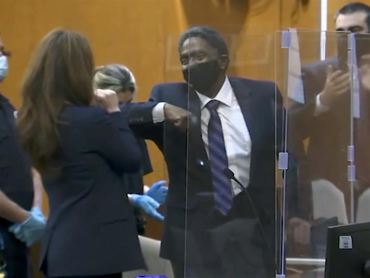 In this image made from video provided by WABC TV, Jaythan Kendrick, center, celebrates in a New York City courtroom, Thursday, Nov. 19, 2020, after being cleared of the November 1994 killing of Josephine Sanchez. After more than a quarter-century behind bars for the deadly purse-snatching, the New York man has been cleared as prosecutors acknowledged that witnesses against him, including a 10-year-old boy, weren't reliable. (WABC TV via AP)