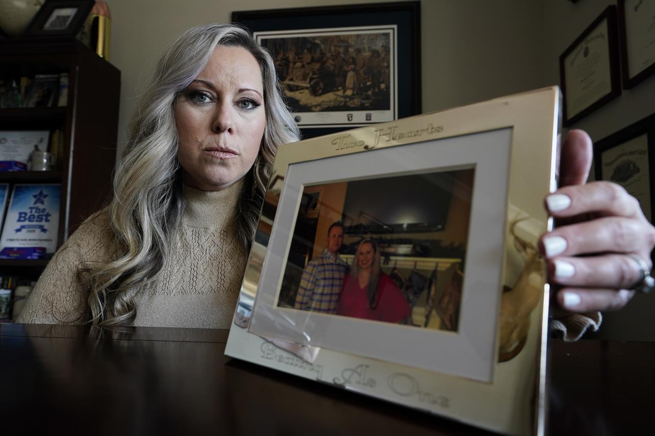 Jill Cichowicz, an advocate for opioid addiction treatment, displays a photo of her and her brother, Scott Zebnwski, who died of an opioid overdose at age 38, in her home in Midlothian, Va., Tuesday, Nov. 24, 2020. (AP Photo/Steve Helber)
