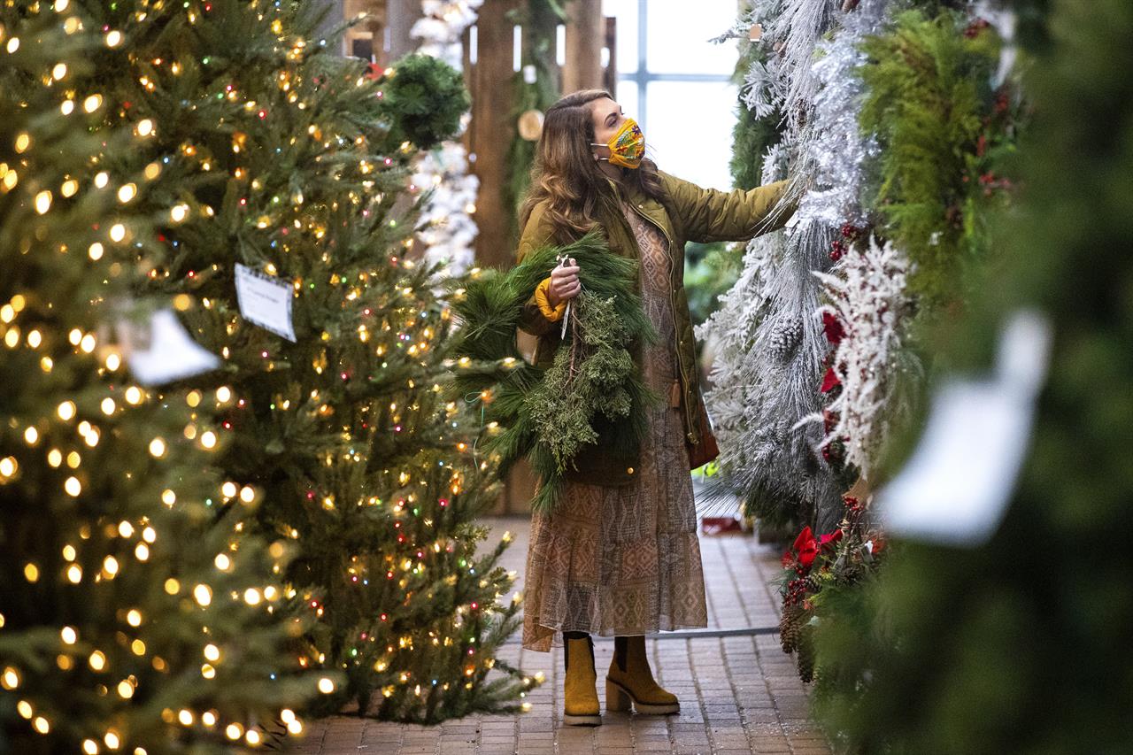 Amanda Perrone shops for Christmas decorations on Black Friday, at Corky's Garden Path Greenhouse in Scott Twp., Pa. on Friday, Nov. 27, 2020. (Christopher Dolan/The Times-Tribune via AP)