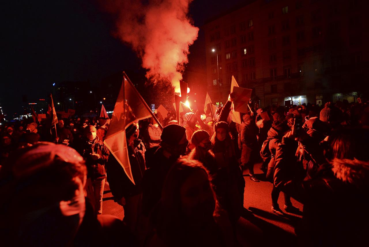 People demonstrate against police violence and an attempted restriction on abortion rights in Warsaw Poland, Saturday, Nov. 28, 2020. Nationwide protests Saturday were scheduled to coincide with Polish women gaining the right to vote 102 years ago. Weeks of protests against a high court's ruling to further restrict Abortion rights have evolved into the largest protest movement since communism fell 30 years ago.(AP Photo/Czarek Sokolowski)