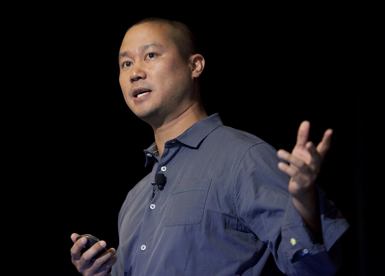 FILE - In this Sept. 30, 2013, file photo, Tony Hsieh speaks during a Grand Rapids Economic Club luncheon in Grand Rapids, Mich. Hsieh, retired CEO of Las Vegas-based online shoe retailer Zappos.com, has died. Hsieh was with family when he died Friday, Nov. 27, 2020, according to a statement from DTP Companies, which he founded. Downtown Partnership spokesperson Megan Fazio says Hsieh passed away in Connecticut, KLAS-TV reported. Hsieh recently retired from Zappos after 20 years leading the company. He worked to revitalize the Las Vegas area. (Cory Morse/The Grand Rapids Press via AP, File)