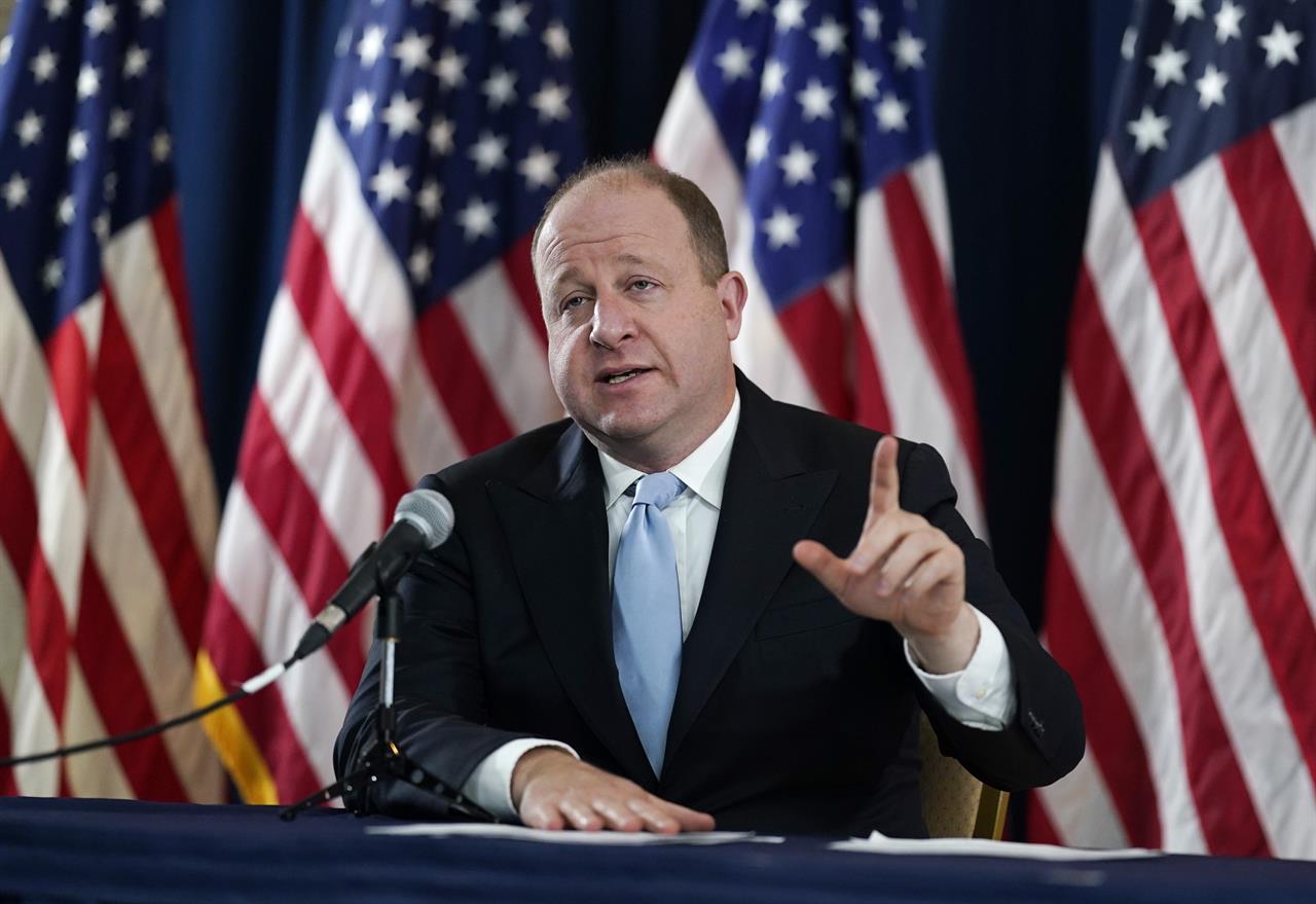 FILE - Colorado Gov. Jared Polis speaks during a news conference about the state's response to the rapid increase in COVID-19 cases, Tuesday, Nov. 24, 2020, in Denver. Faulting inaction in Washington, governors and state lawmakers are racing to get needed pandemic relief to small businesses, the unemployed, renters and others affected by the widening coronavirus outbreak. (AP Photo/David Zalubowski, File)