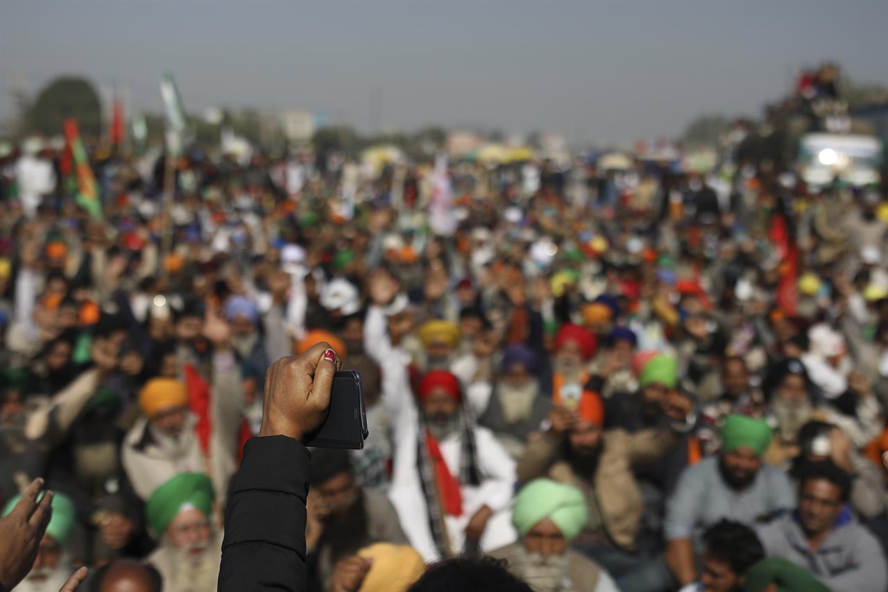 Protesting farmers shout slogans while blocking a major highway, refusing to move ahead unless they're allowed to proceed to their place of choice to protest, at the Delhi-Haryana state border, India, Saturday, Nov. 28, 2020. Thousands of farmers in and around the Indian capital on Saturday pressed on with their protest against agricultural legislation they said could devastate crop prices, while the government sought talks with their leaders. (AP Photo/Altaf Qadri)