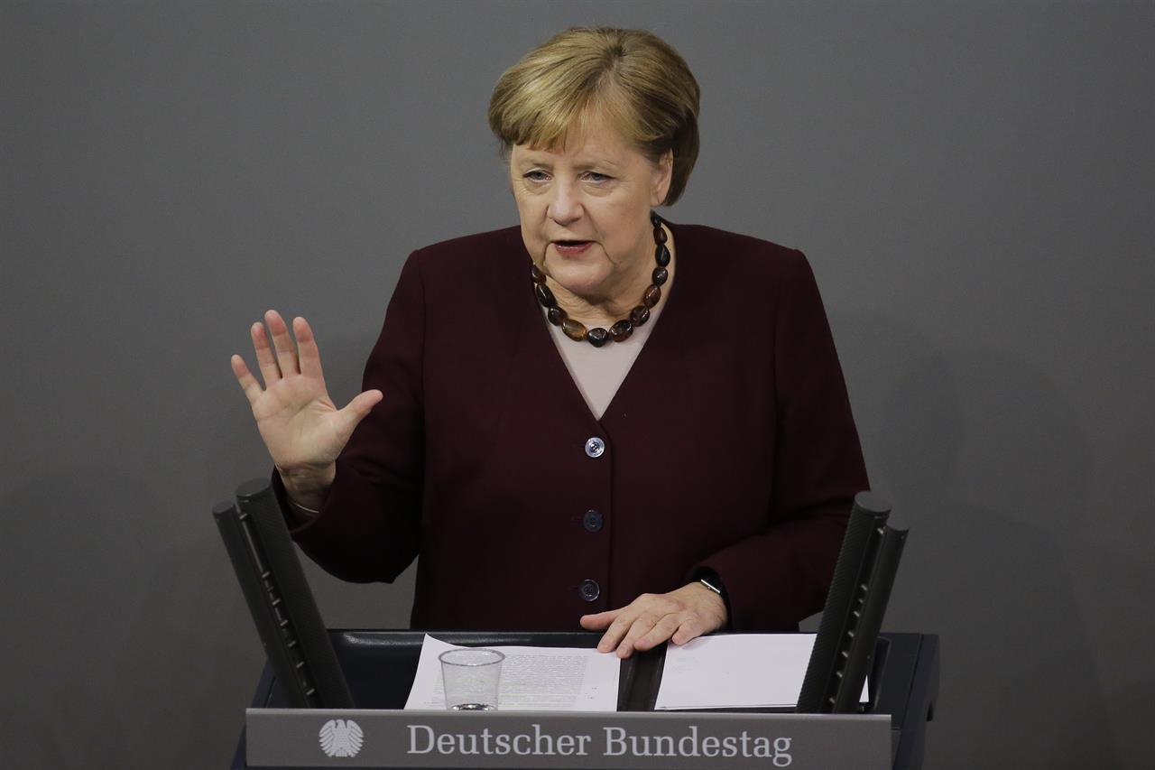 German Chancellor Angela Merkel delivers a speech about German government's policies to combat the spread of the coronavirus and COVID-19 disease at the parliament Bundestag, in Berlin, Germany, Thursday, Nov. 26, 2020. Merkel and the country's 16 state governors have agreed to extend a partial shutdown well into December in an effort to further reduce the rate of coronavirus infections ahead of the Christmas period. (AP Photo/Markus Schreiber)