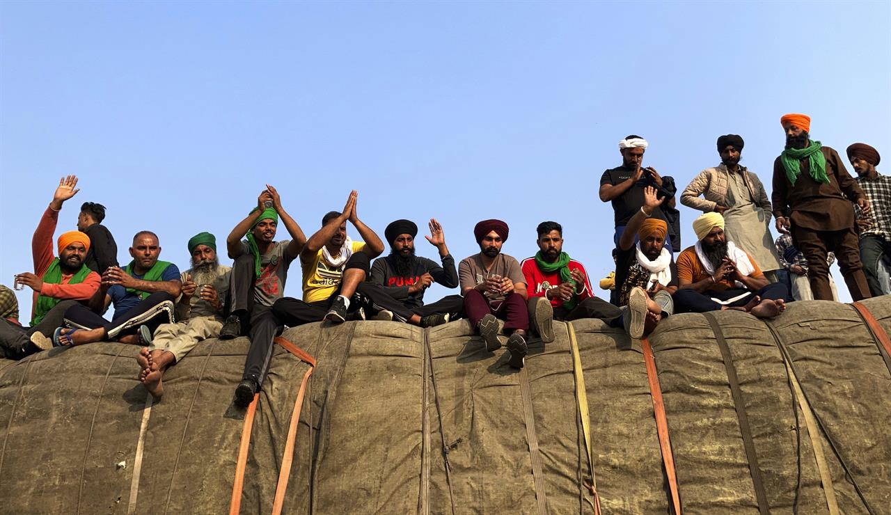 Indian farmers protesting new agriculture laws hold a meeting at the Delhi-Haryana state border, Monday, Nov. 30, 2020. Indian Prime Minister Narendra Modi tried to placate thousands of farmers protesting new agriculture laws Monday and said they were being misled by opposition parties and that his government would resolve all their concerns. (AP Photo/Rishi Lekhi)
