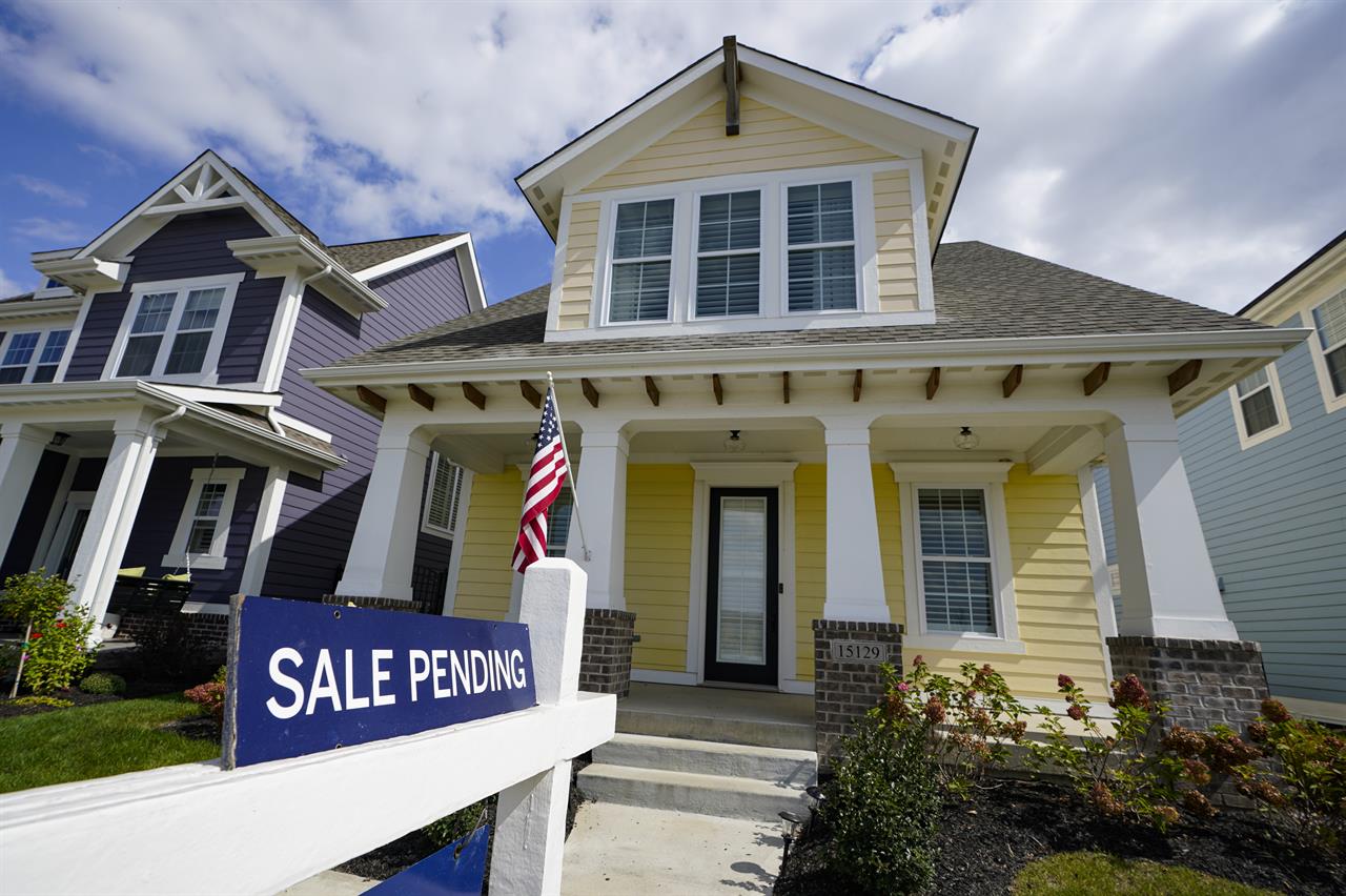A "sale pending" sign is posted on.a home in Westfield, Ind., Friday, Sept. 25, 2020. Sales of new homes remained steady in October at a seasonally adjusted rate of 999,000 units. While the Commerce Department said October new home sales were down 0.3% from September, the government revised up its September figure marginally. (AP Photo/Michael Conroy)