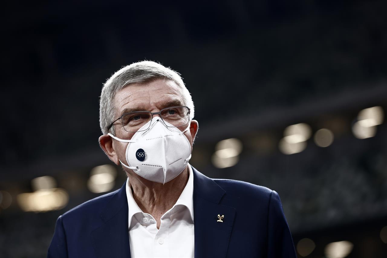 IOC President Thomas Bach visits the National Stadium, the main venue for the 2020 Olympic and Paralympic Games postponed until July 2021 due to the coronavirus pandemic, in Tokyo Tuesday, Nov. 17, 2020. Bach said during this week's trip to Tokyo that he is “encouraging” all Olympic “participants” and fans to be vaccinated - if one becomes available - if they are going to attend next year's Tokyo Olympics. (Behrouz Mehri/Pool Photo via AP)