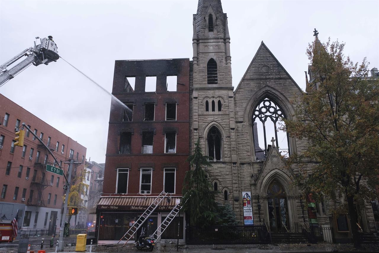 Firefighters work to extinguish a fire erupted from the building next to Middle Collegiate Church on Saturday, Dec. 5, 2020 in New York. The historic 19th century church in lower Manhattan was gutted by a massive fire early Saturday that sent flames shooting through the roof. (AP Photo/Yuki Iwamura)