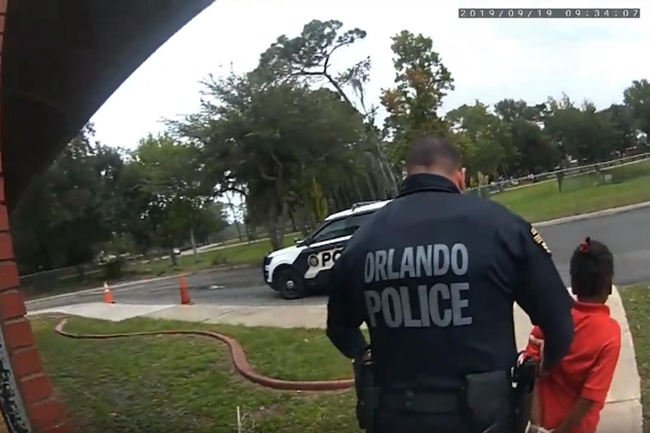 In this image taken from Sept. 19, 2019, Orlando Police Department body camera video footage, Orlando Police Officer Dennis Turner leads 6-year-old Kaia Rolle away after her arrest for kicking and punching staff members at the Lucious & Emma Nixon Academy Charter School in Orlando, Fla. Turner was fired shortly after the arrest for not getting the approval of a watch commander to arrest someone younger than 12. (Orlando Police Department/Orlando Sentinel via AP)
Body cam captures 6-year-old's tearful pleas during arrest